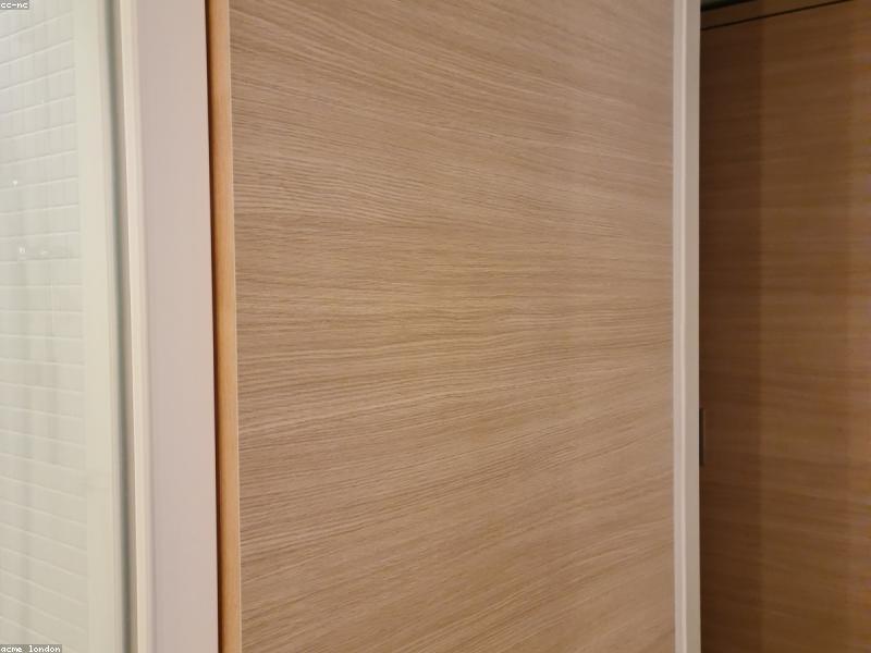 Østerbro bathroom clad in travertine with a freestanding stone basin and brass fittings